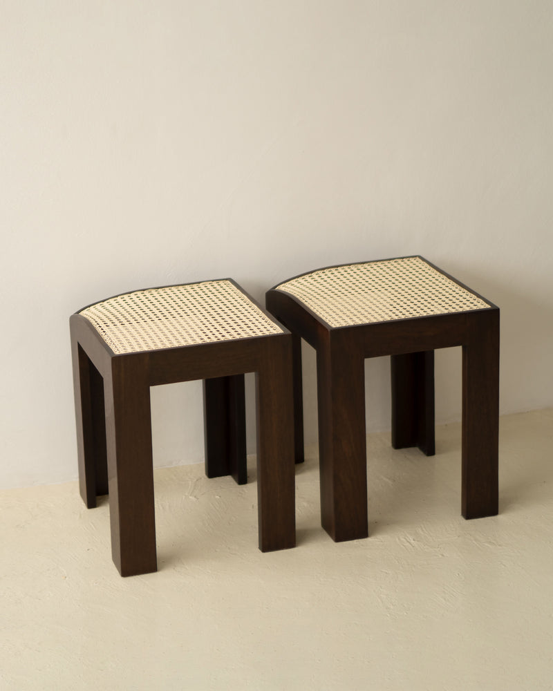 Two Canto wooden stools with woven cane seats by Andre Grippi