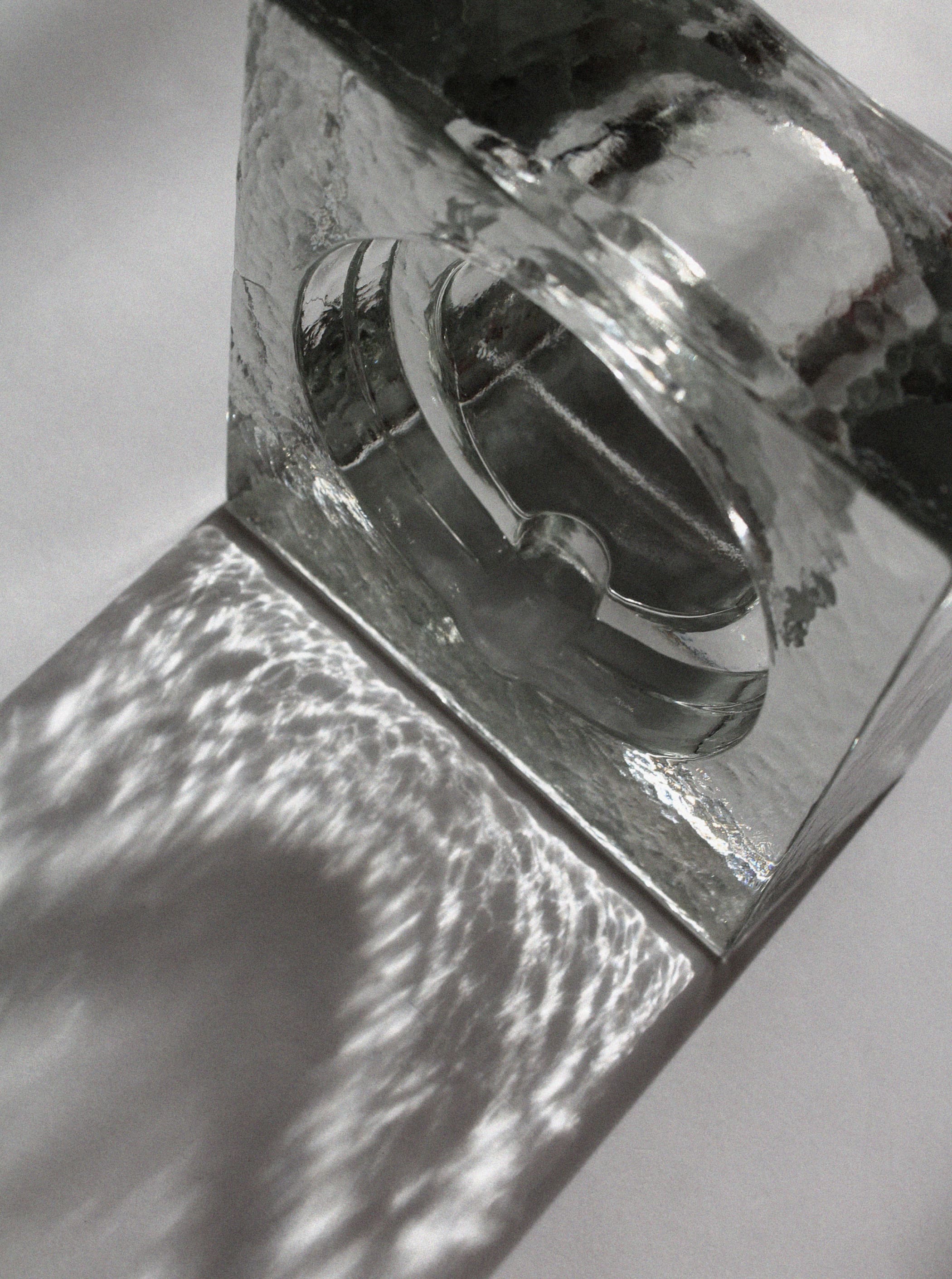 Clear ice glass ashtray bowl showing thick walls and curved edges
