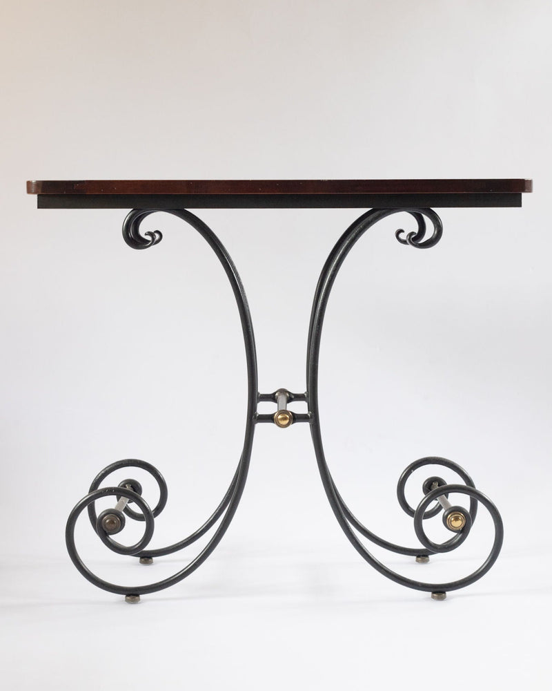 Elegant iron console table with scrolled legs and dark wood top