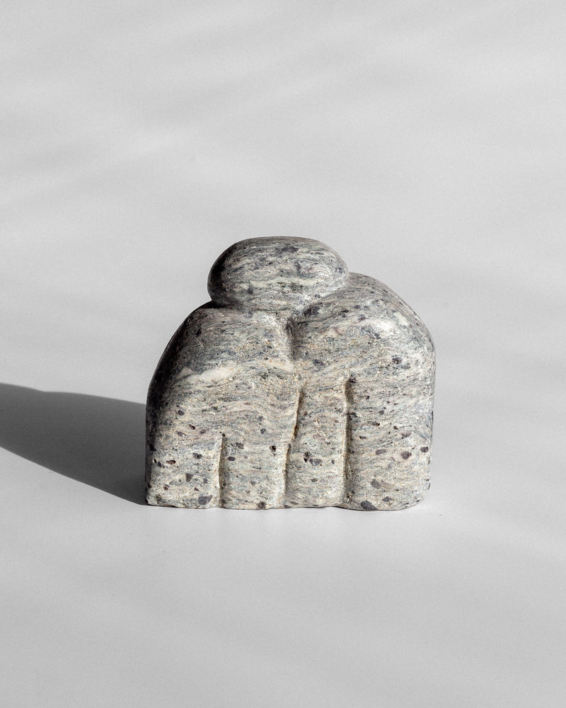 Sculptural stone artwork with carved finger-like forms detail