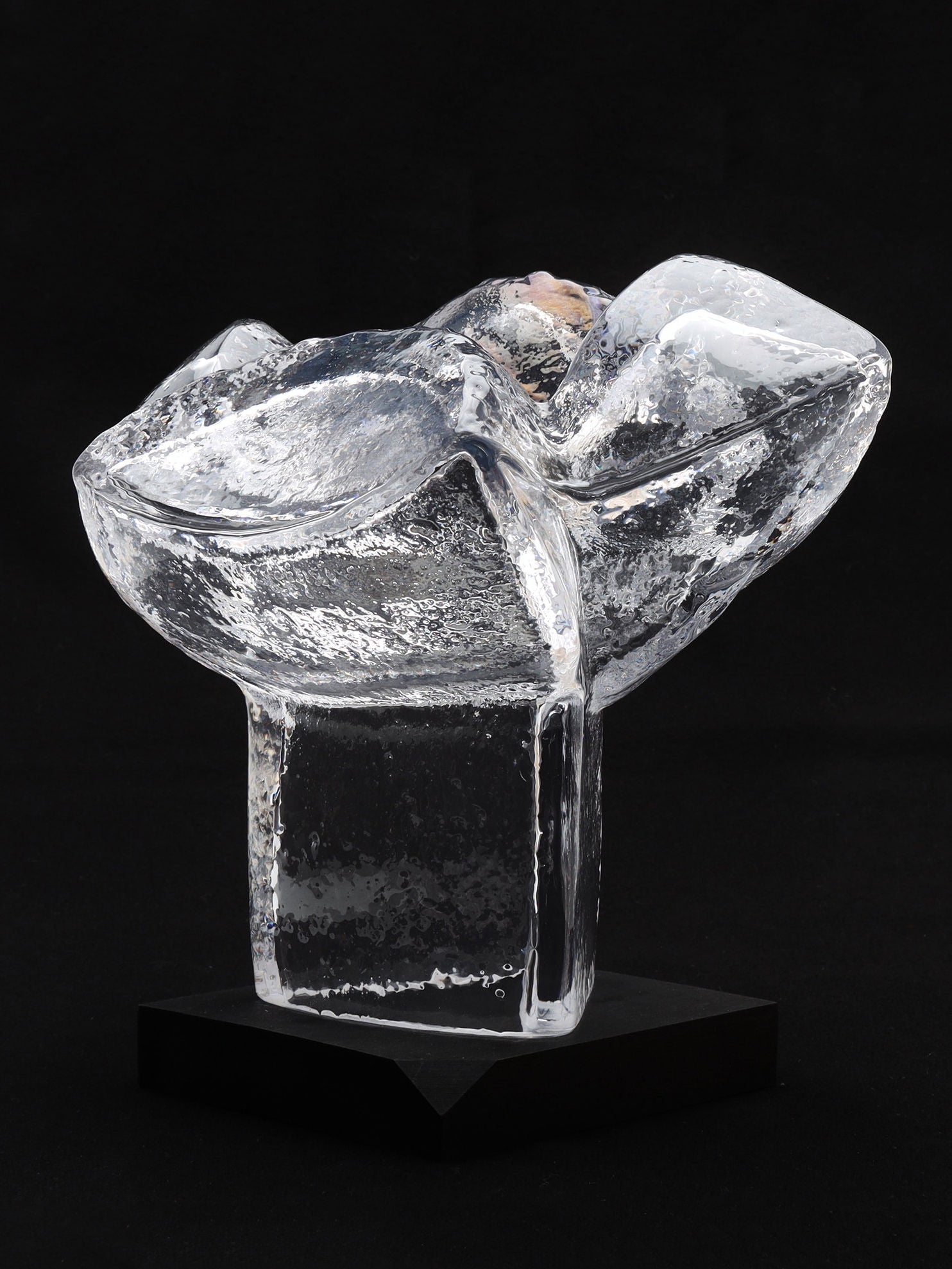 An elegant piece by RELIC LONDON, the Very Large Abstract Glass Sculpture features modern, organic shapes. Crafted from clear glass with a smooth, polished finish, it rests on a rectangular base for a sophisticated and contemporary look. This Sweden-inspired sculpture captivates art collectors with its intricate internal textures.