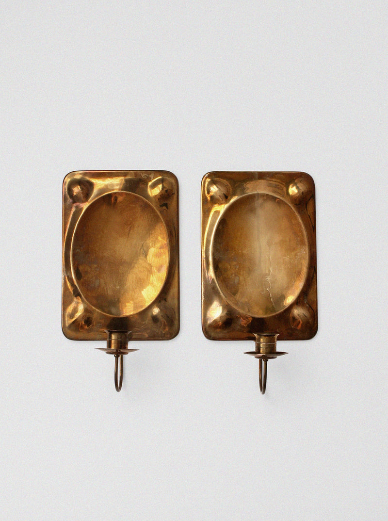 Pair of brass wall candle sconces with oval reflector backs