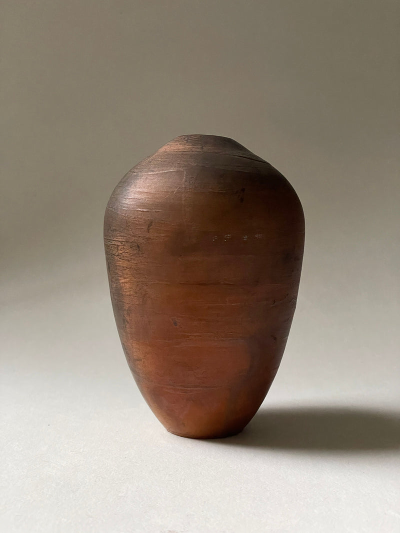 Brown ceramic studio pottery vase with organic oval form