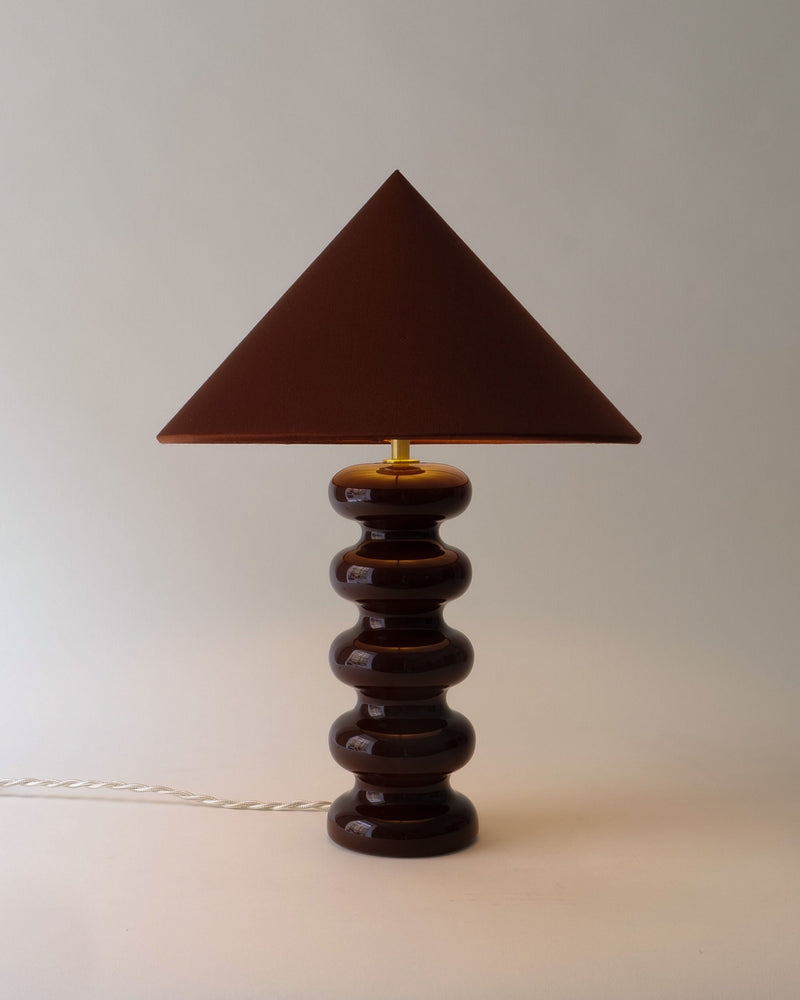 Sculptural ceramic table lamp with triangular shade in amber tones