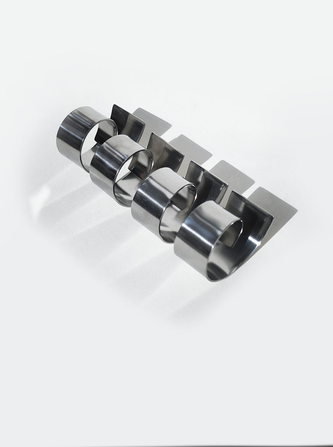 Polished stainless steel spiral napkin rings set detail view