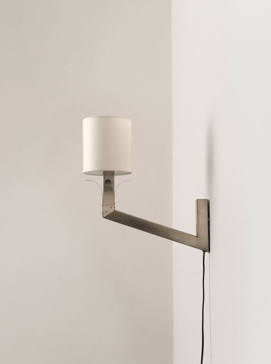 Stainless wall lamp 01 in brushed stainless steel finish with frosted glass shade