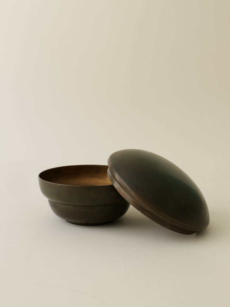 Vintage bronze jar with lid open showing interior detail