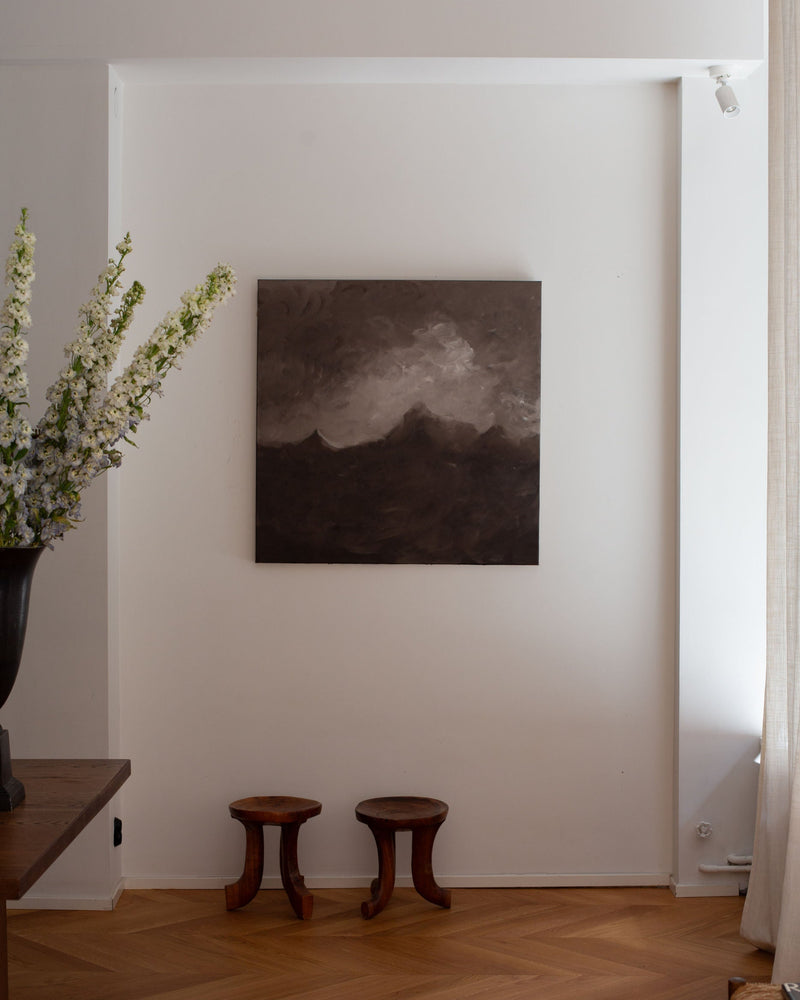 Moody landscape painting "The Quiet Rise" displayed in minimalist interior