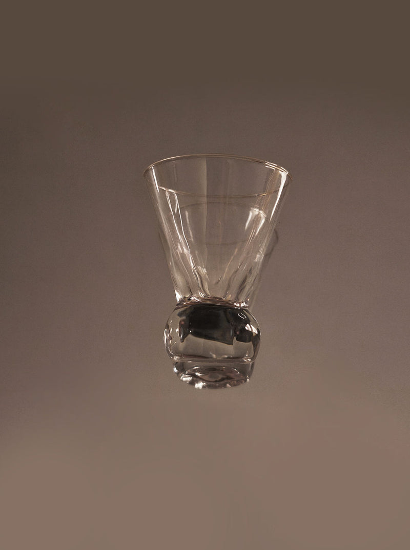 Clear glass shot glass with rounded base detail view
