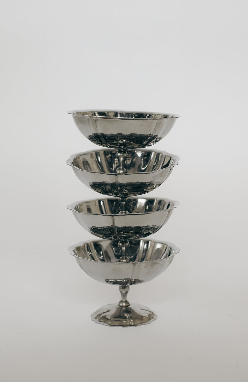 Stacked chrome ice coupes showing reflective metallic finish