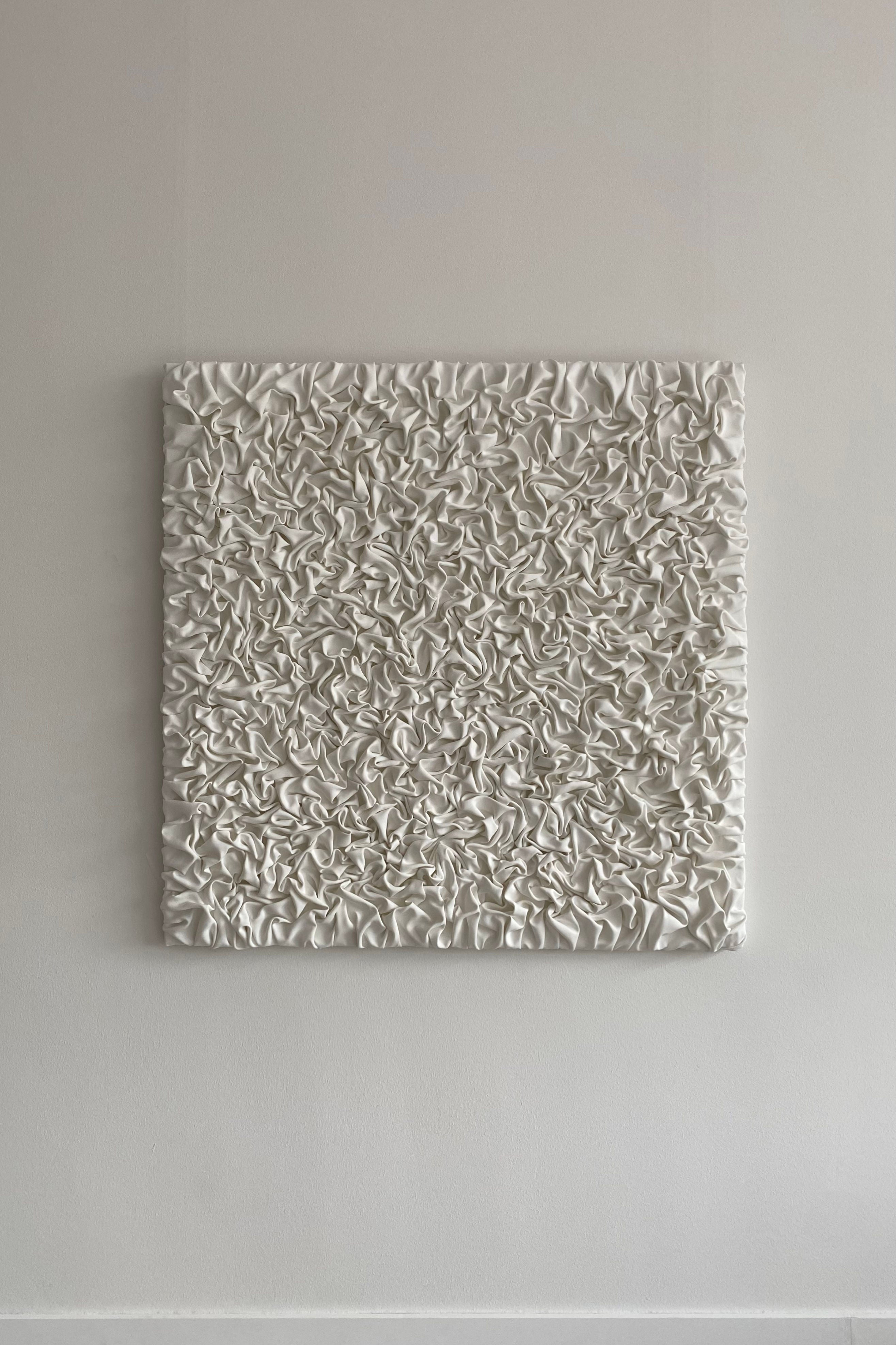 ESCAPISM 108' sculptural wall art — textured white surface on wall