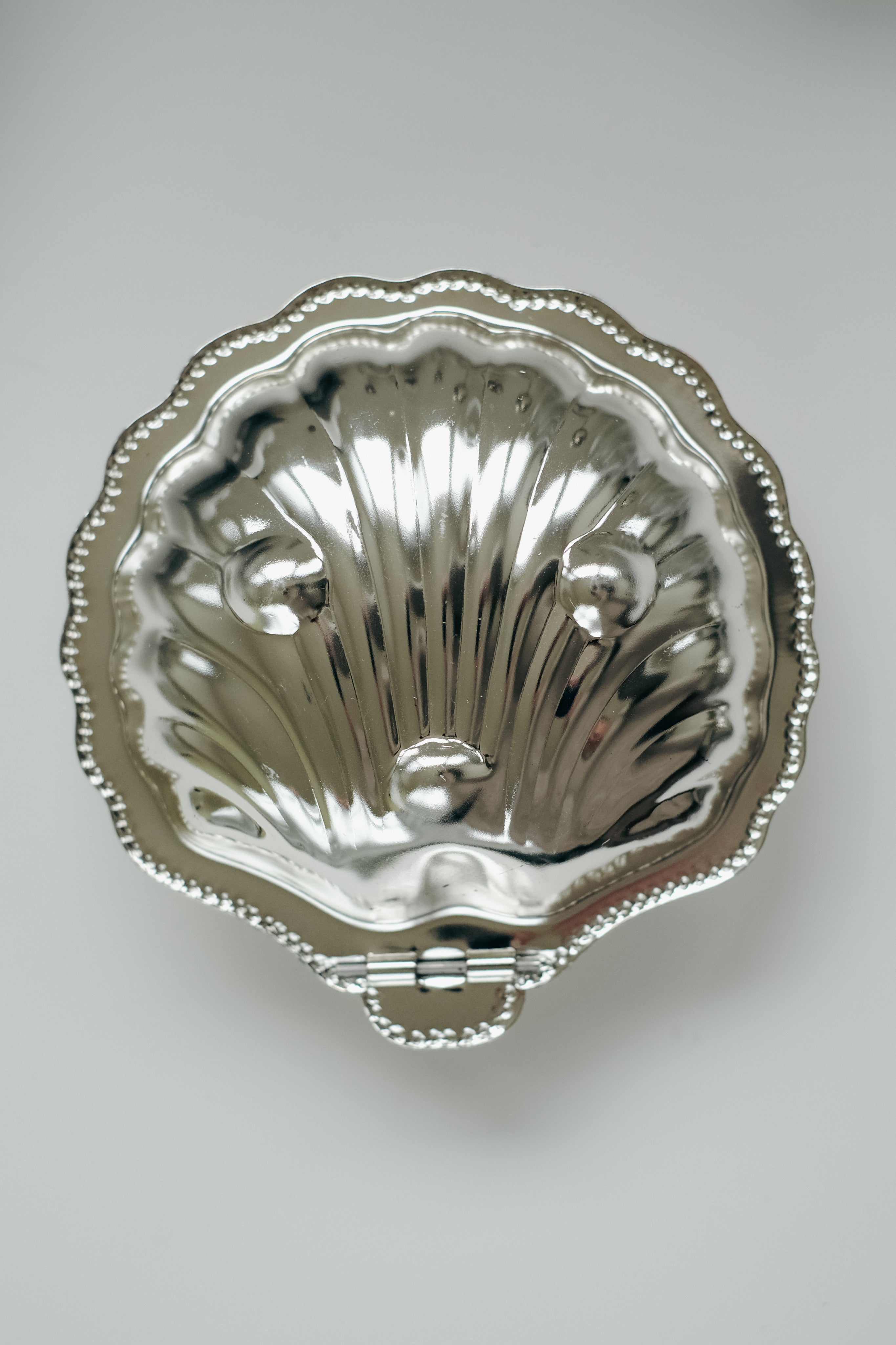 Shell Shaped Butter Dish — top view of polished metal surface