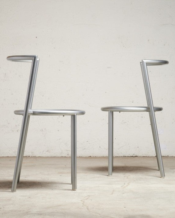 Pair of Metallo Chairs by Sergio Calatroni — angled view against textured wall