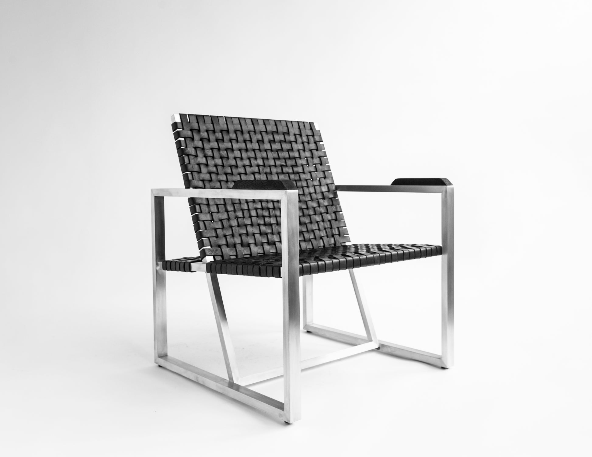 RIA II Lounge Chair — angled view with black woven seat and metal frame