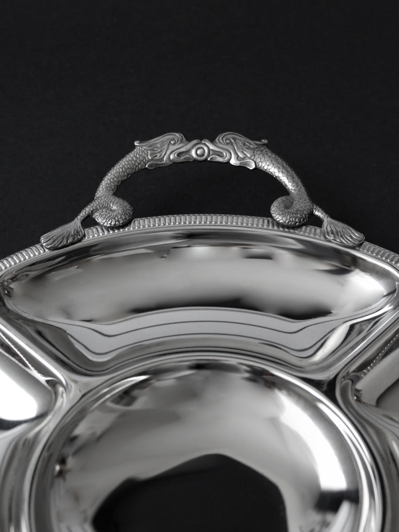 Ornate handle detail of vintage Couzon Orfèvre silver serving tray