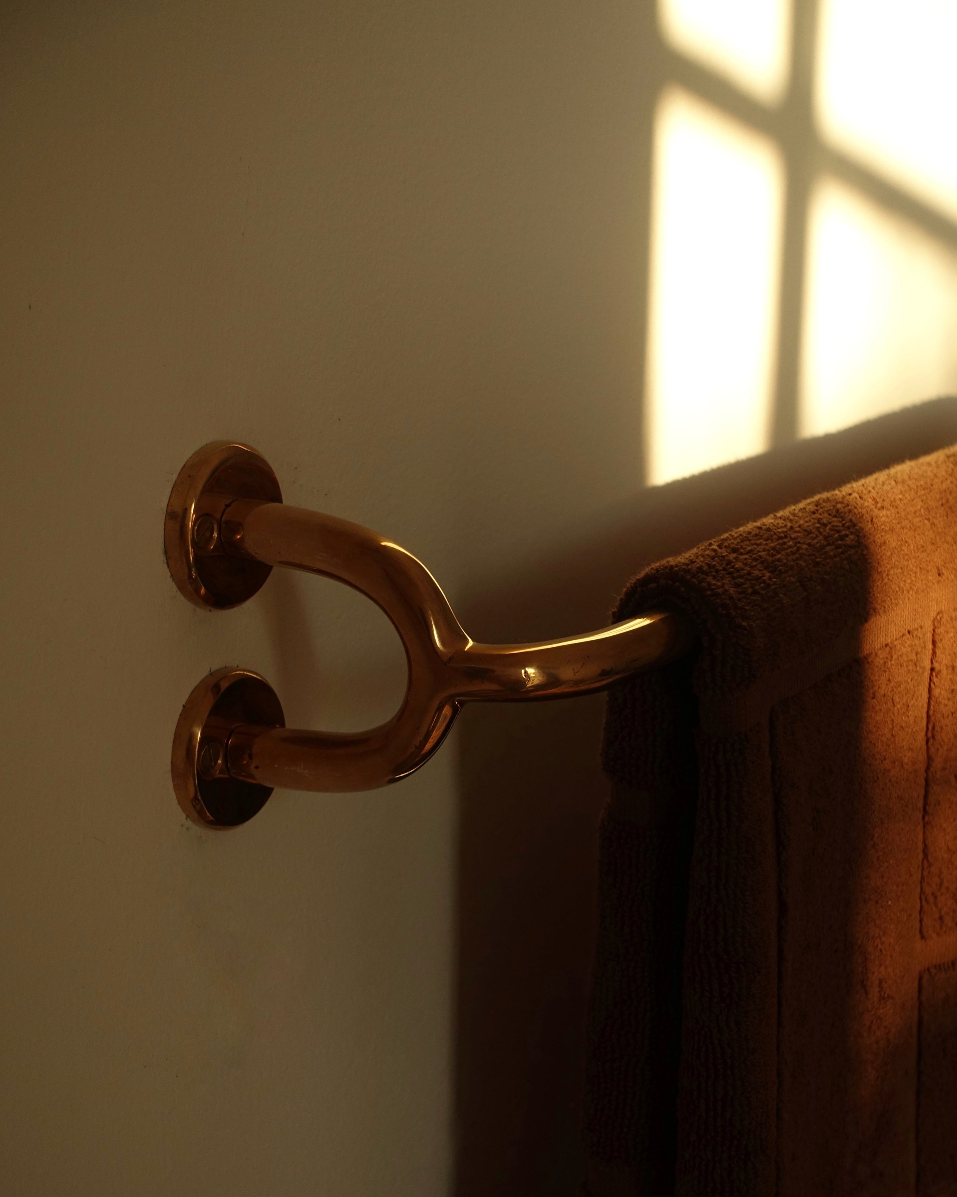 FAUNA Towel Bar (2 sizes) — side angle showing polished brass finish