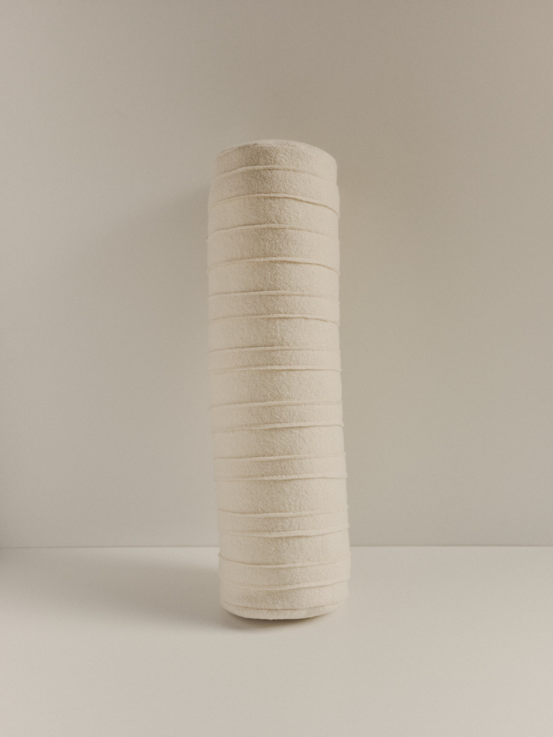 Textured wool bolster cushion by Elle La | The Oblist