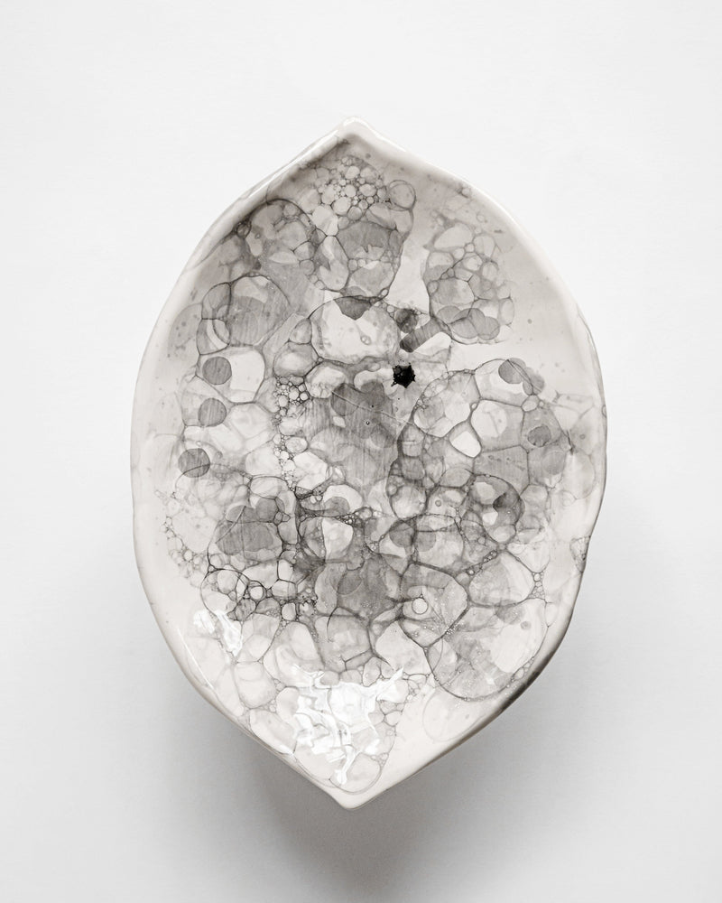 Oval ceramic bowl with organic bubble pattern in white and gray tones