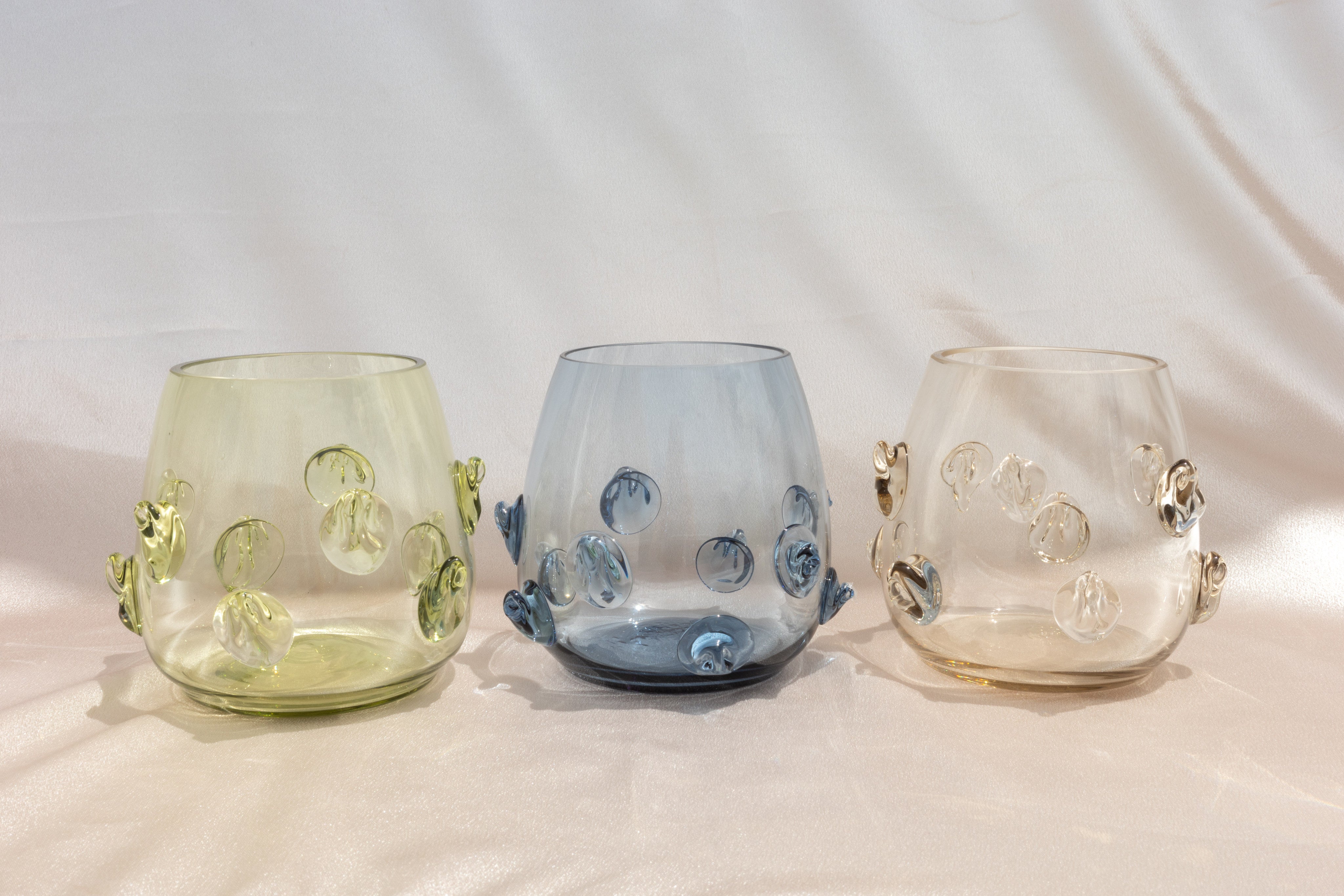 Contemporary Tumblr - Set of four handblown glass vessels — close-up of textured glass colors