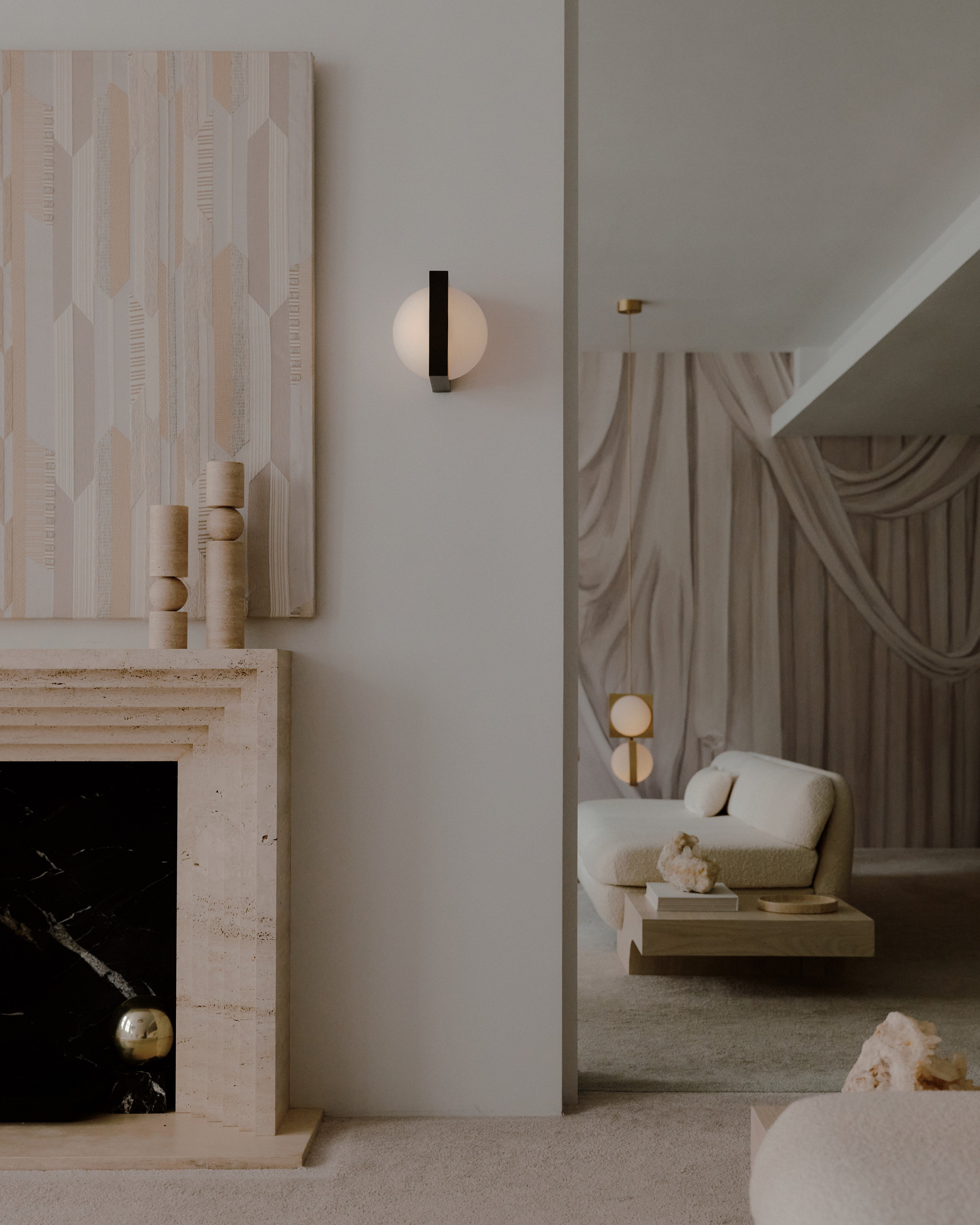 Solstice Wall Light — back view against textured wall in modern setting