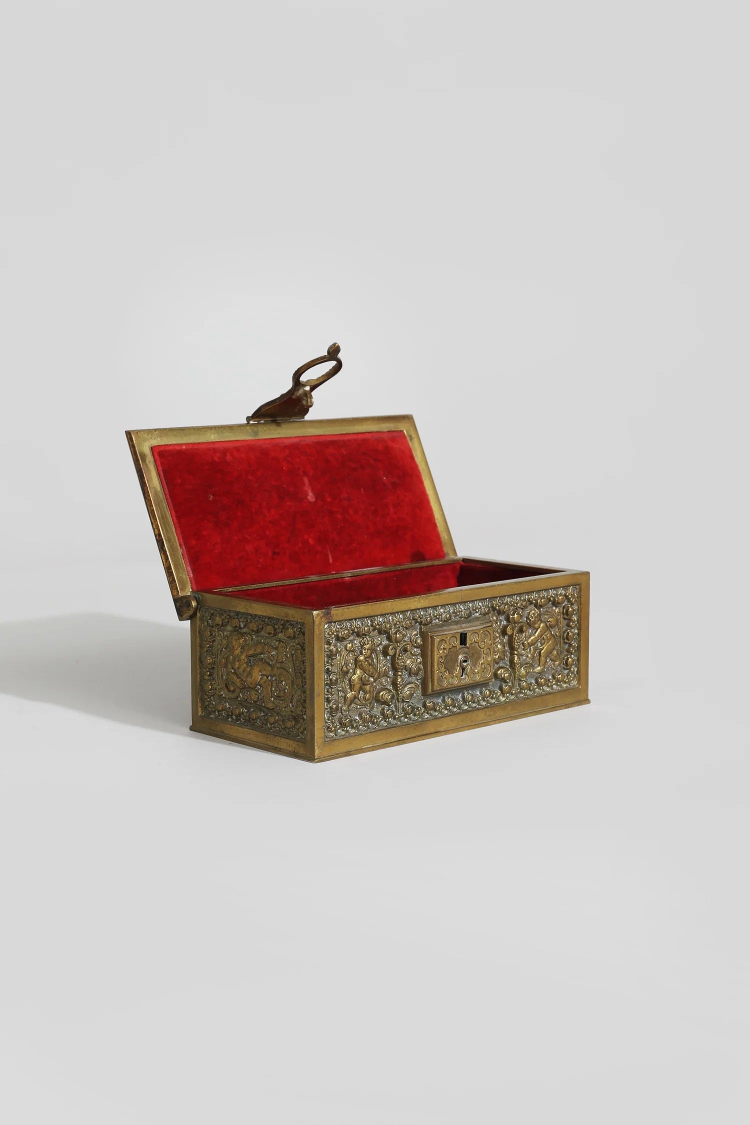 Brass Cherub Jewelry Box — side angle with red velvet interior