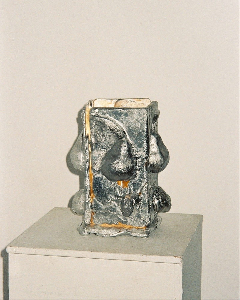 Tender sculptural ceramic table lamp with metallic glazed finish