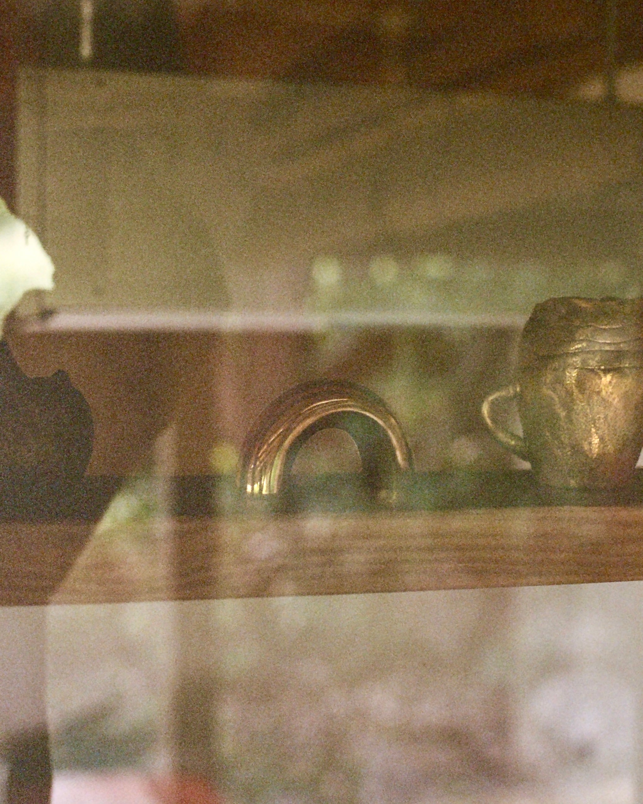 CERCLE Cabinet Pull Thick — top view of brass pull on shelf