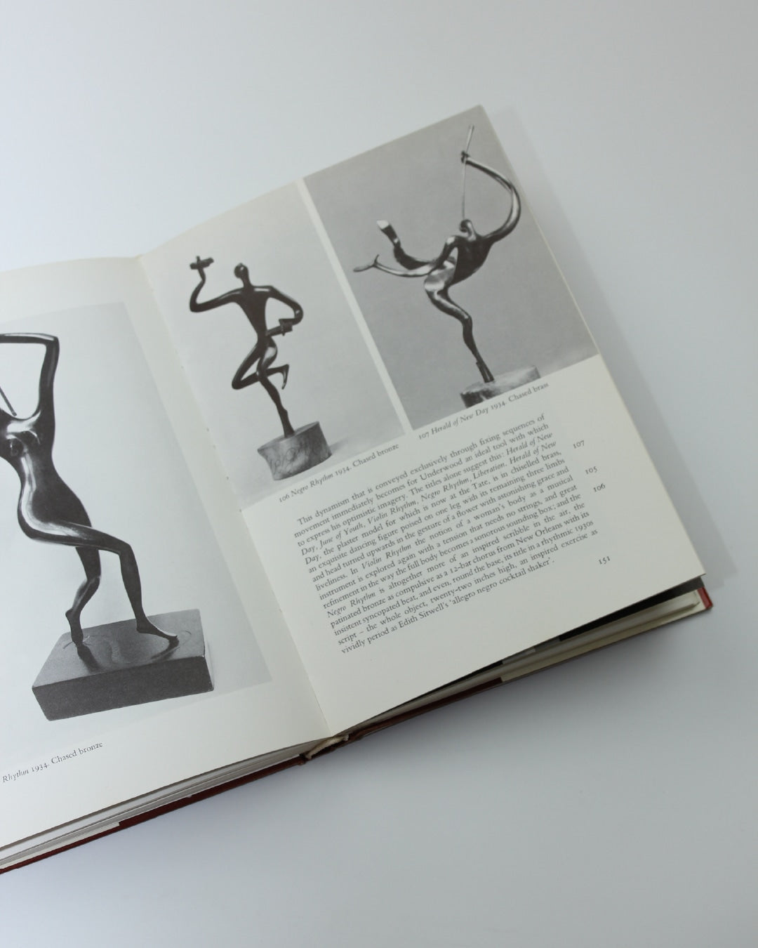 Leon Underwood — open book on white surface with sculptures