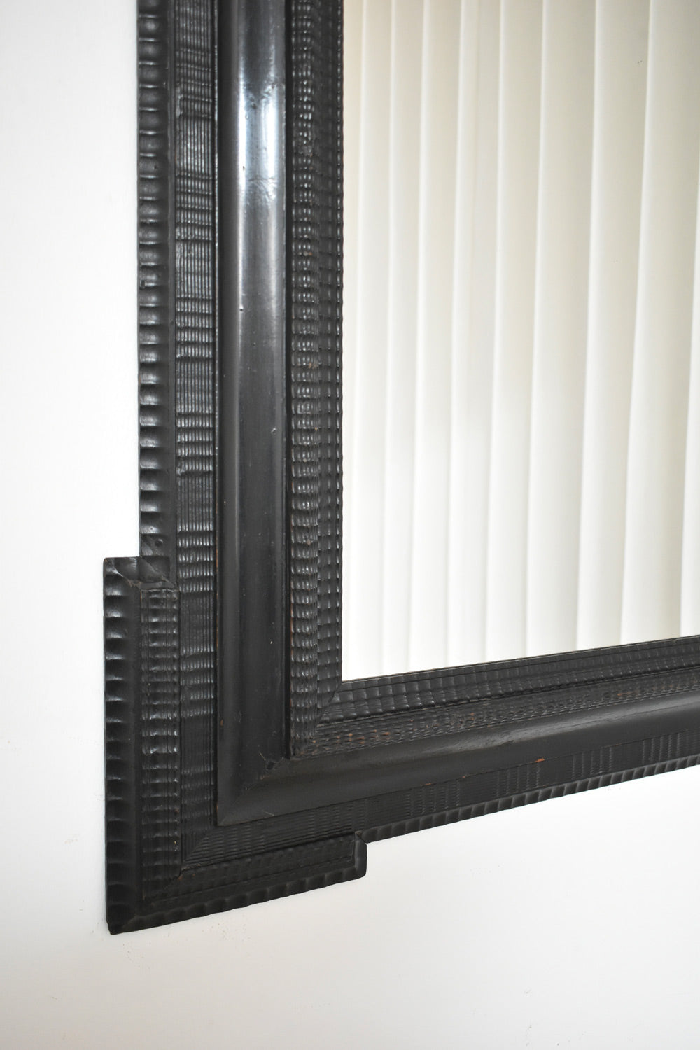 Carved ebonised wooden mirror, XIXth c. — lifestyle setting