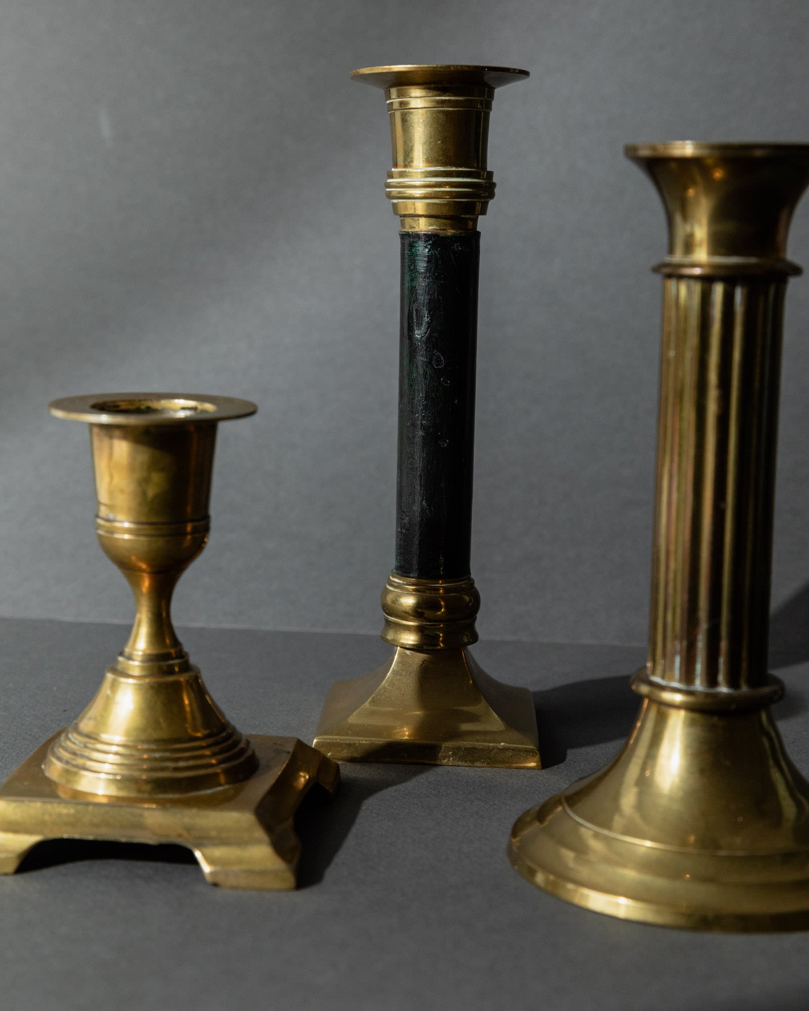 Vintage 1940s Brass Candleholders Set of 3, Mixed Shapes, Classic Antique Design — angled view highlighting different shapes