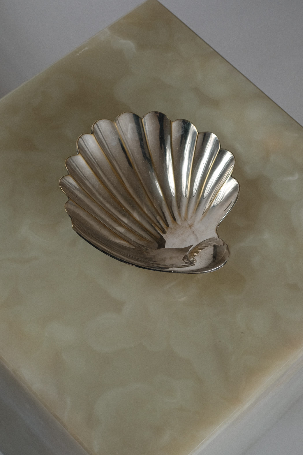 Shell Shaped Vide-Poches — top view of silver shell on marble