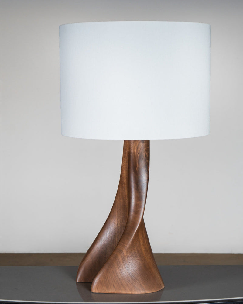 Nile Table Lamp in Natural Stain on Walnut Wood — close-up of curved wooden base