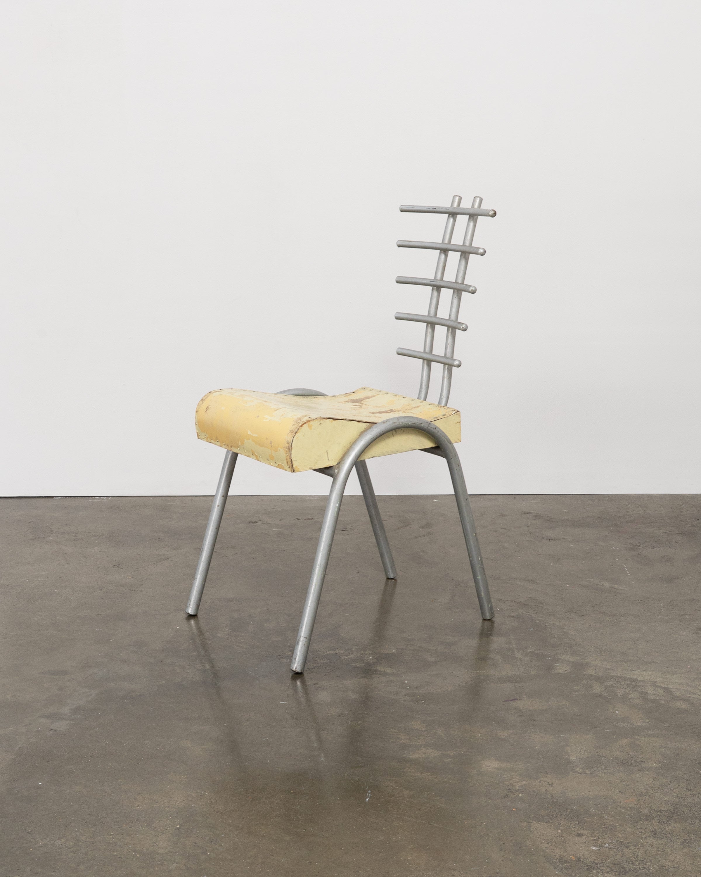 Postmodern prototype chair with yellow foam seat and metal backrest