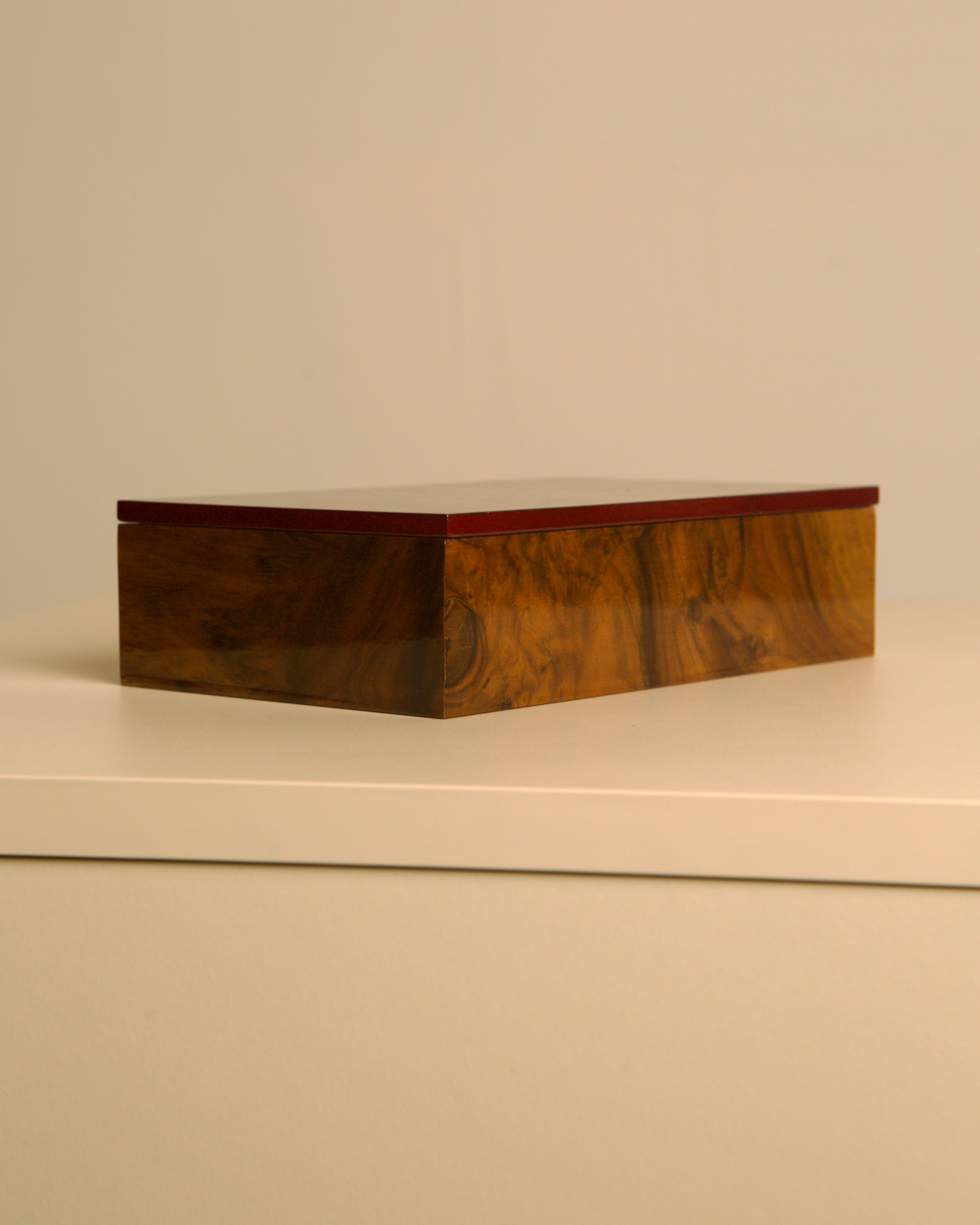 Italian burr walnut box with red interior 80s — angled view on white surface