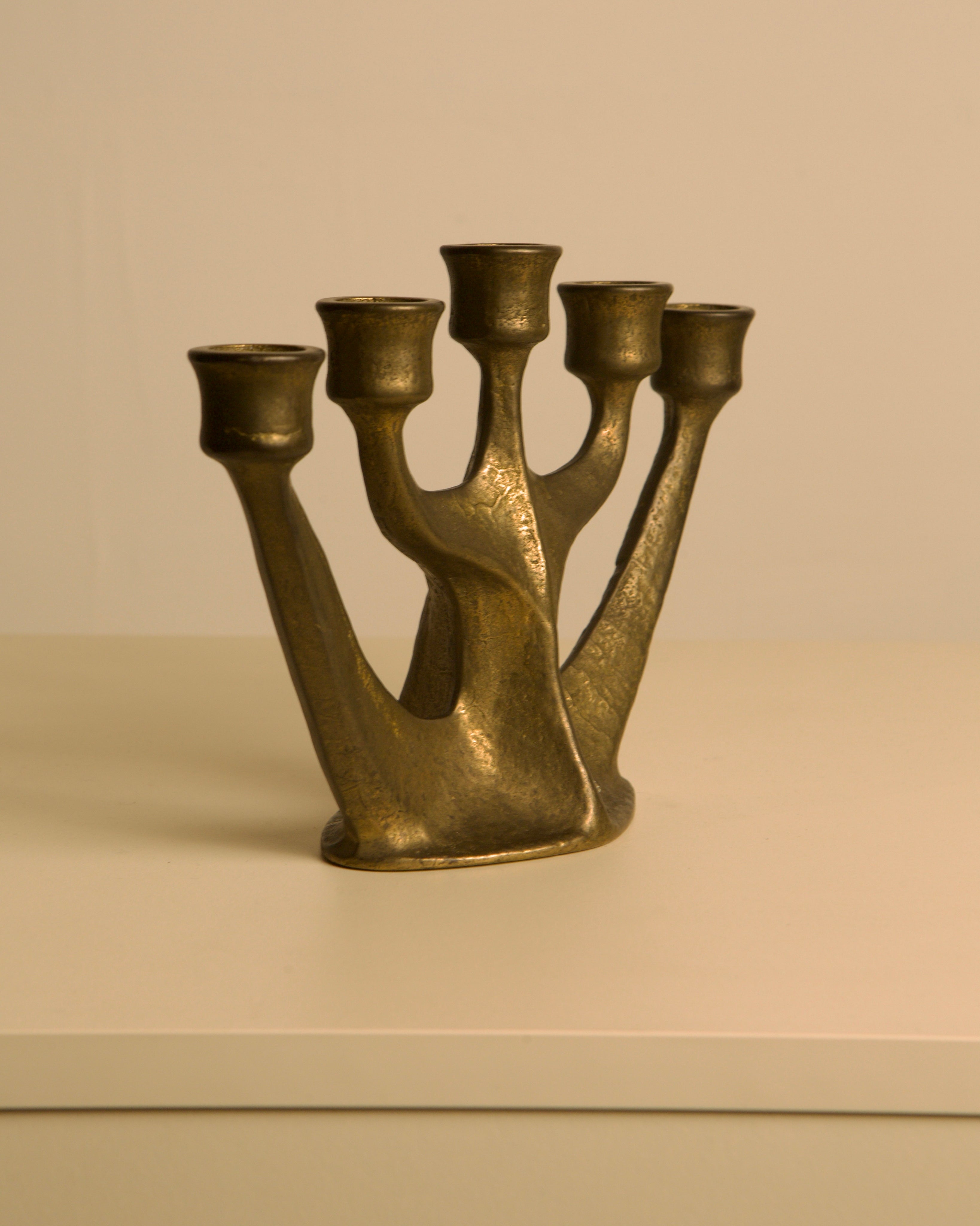 Five-branch Brass Candleholder by Michael Harjes, 1960s — angled view on white surface