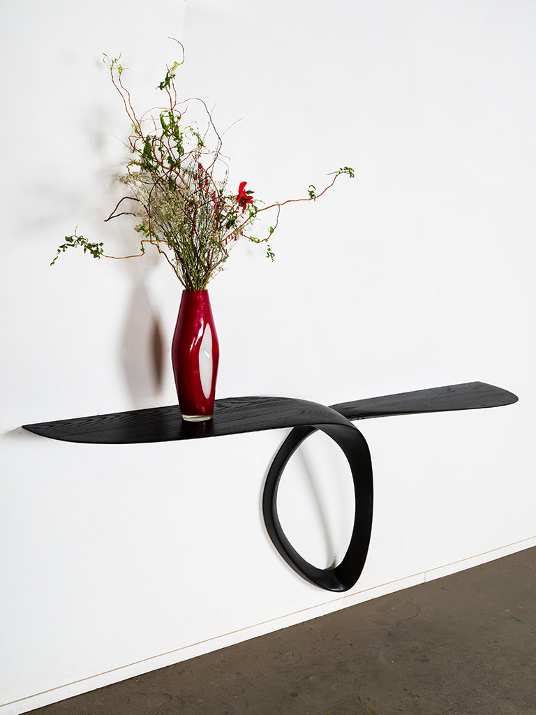 Sculptural Giv Wall Mounted Console Table in Ash wood Ebony stain — lifestyle setting