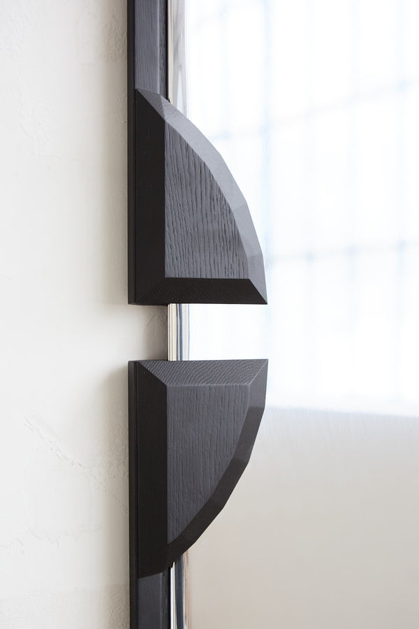 Barrow Mirror in Polished Aluminum — close-up of black wooden frame detail