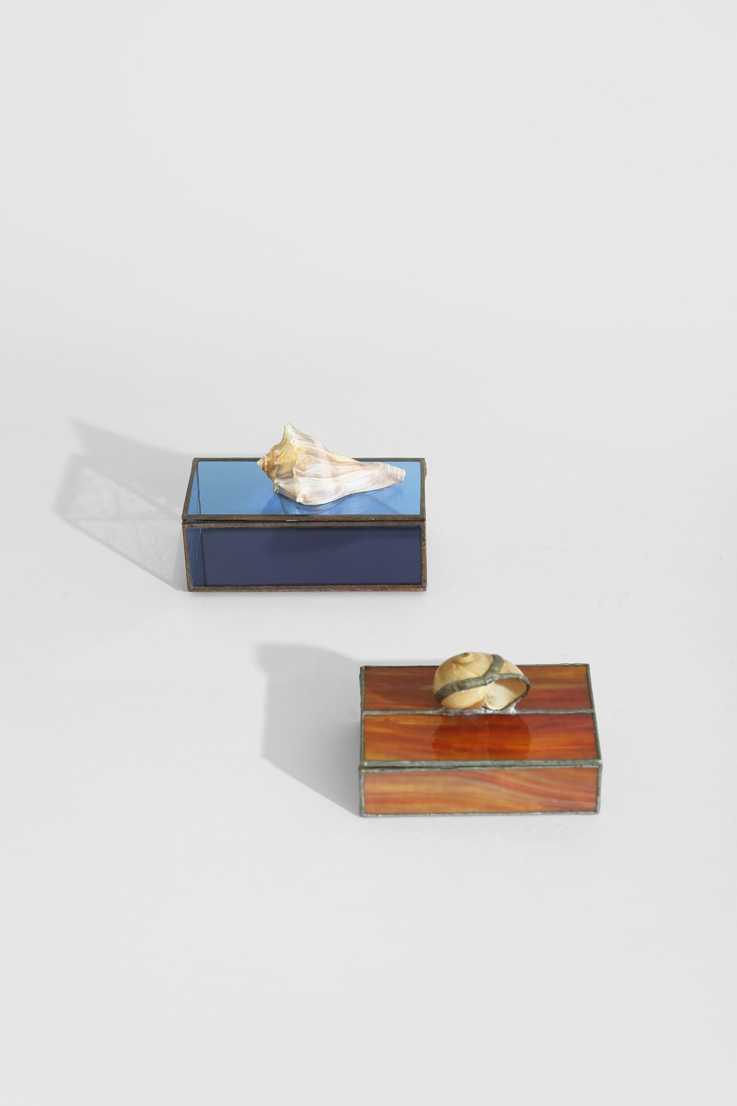 Shell Glass Jewelry Box — angled view showing blue and amber glass surfaces
