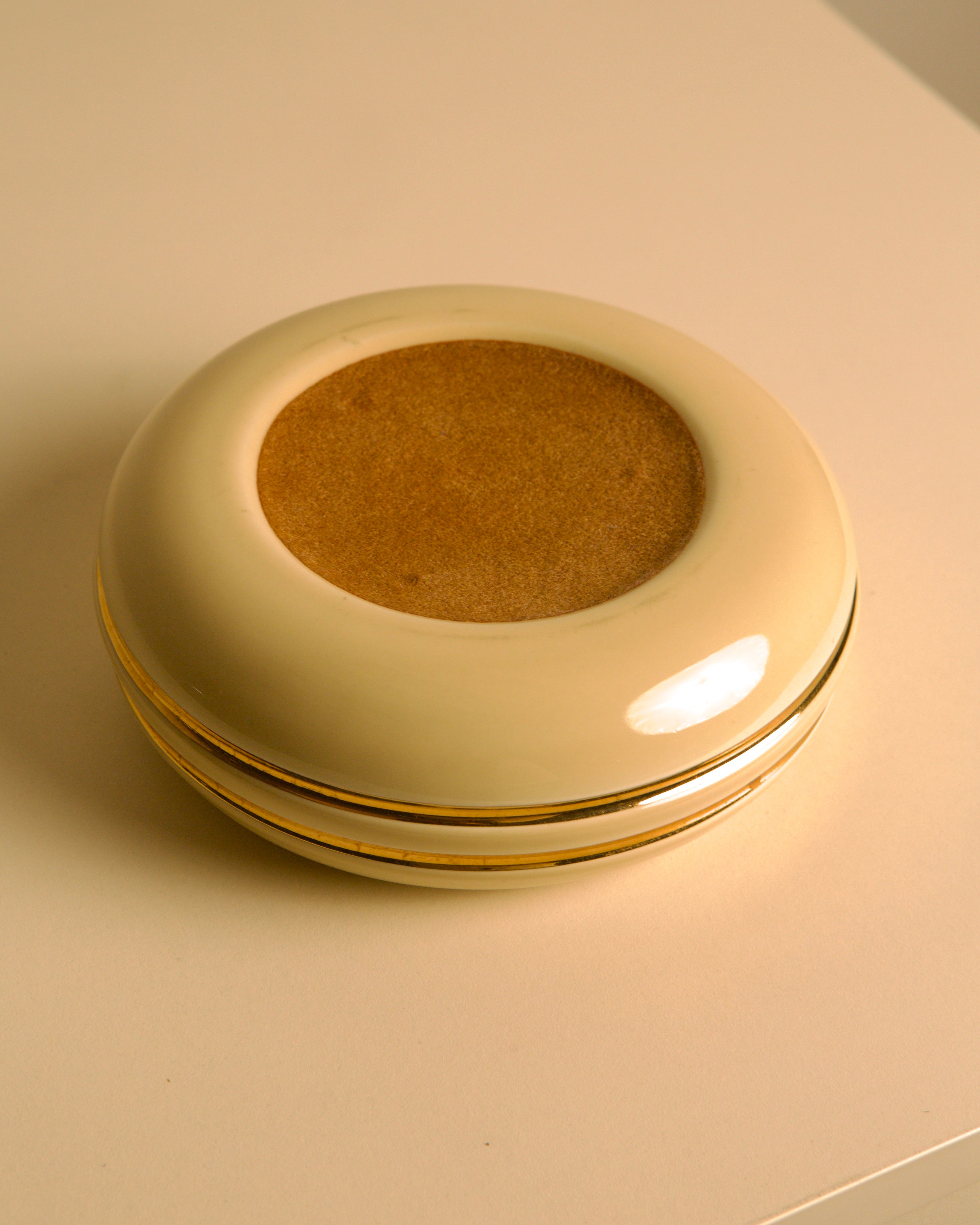 Italian ceramic cream and gold 60's pocket emptier — side angle showing smooth surface and gold trim