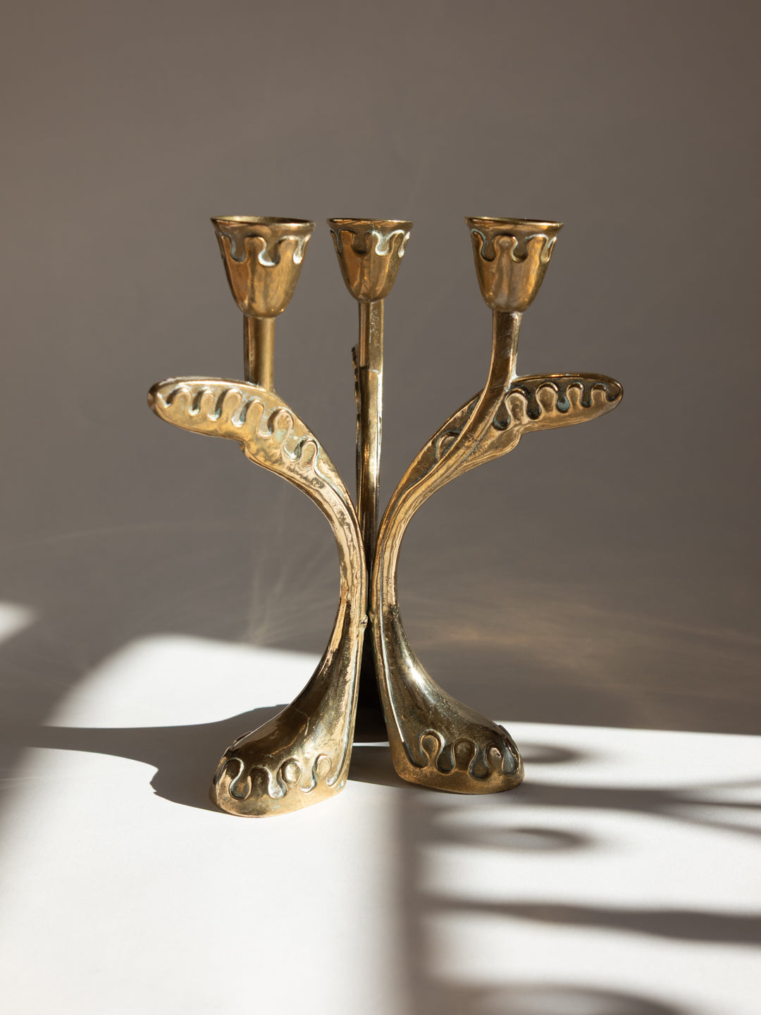 Brass Secessionist Three-Arm Candelabra - Austria, c. 1930s — top view highlighting brass floral design
