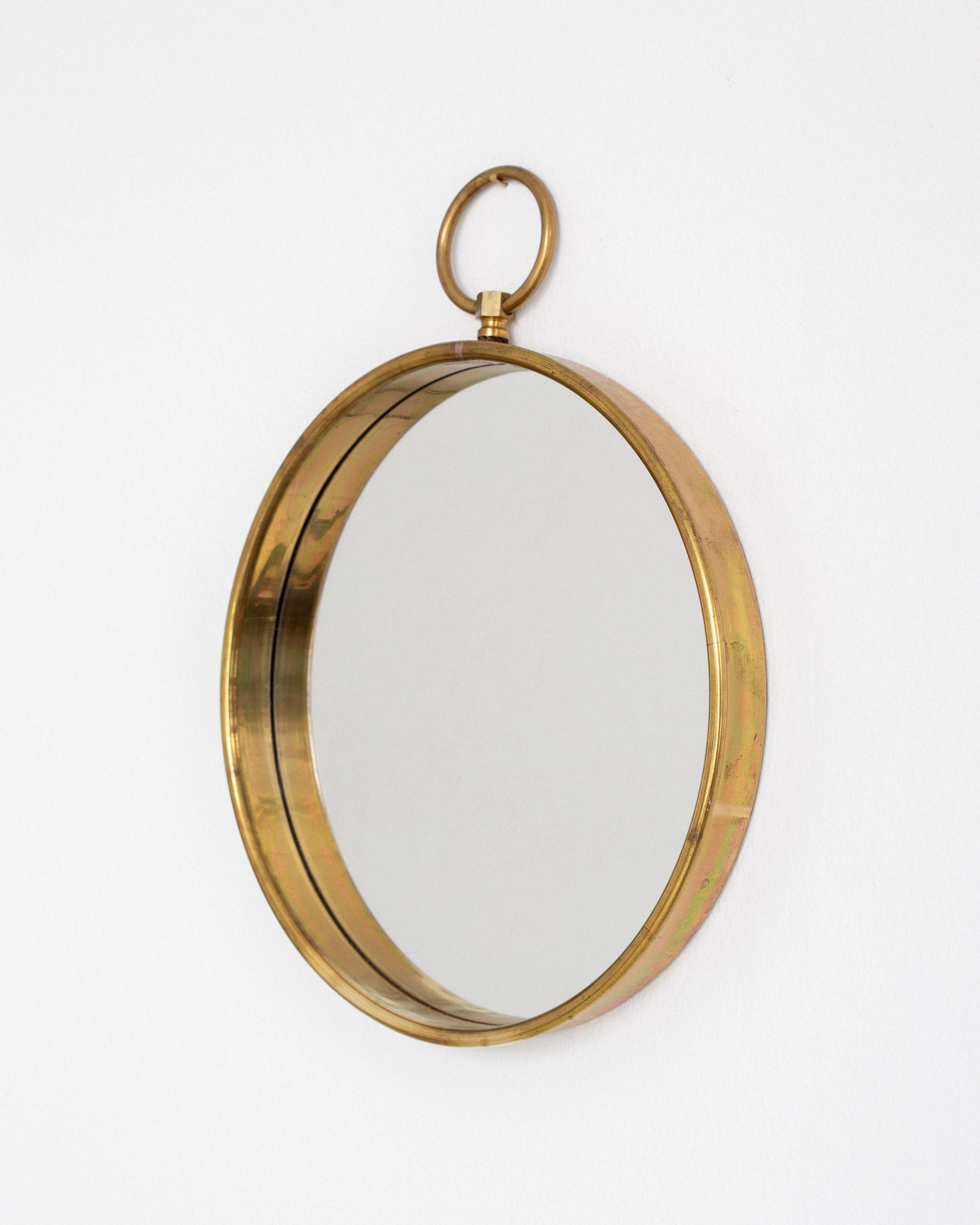 Scandinavian Mid-Century Round Brass Mirror — side angle showing brass frame and hanging loop