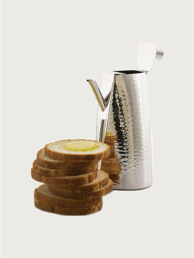 Platinum-plated Oil and Vinegar Set — close-up of hammered surface with bread slices