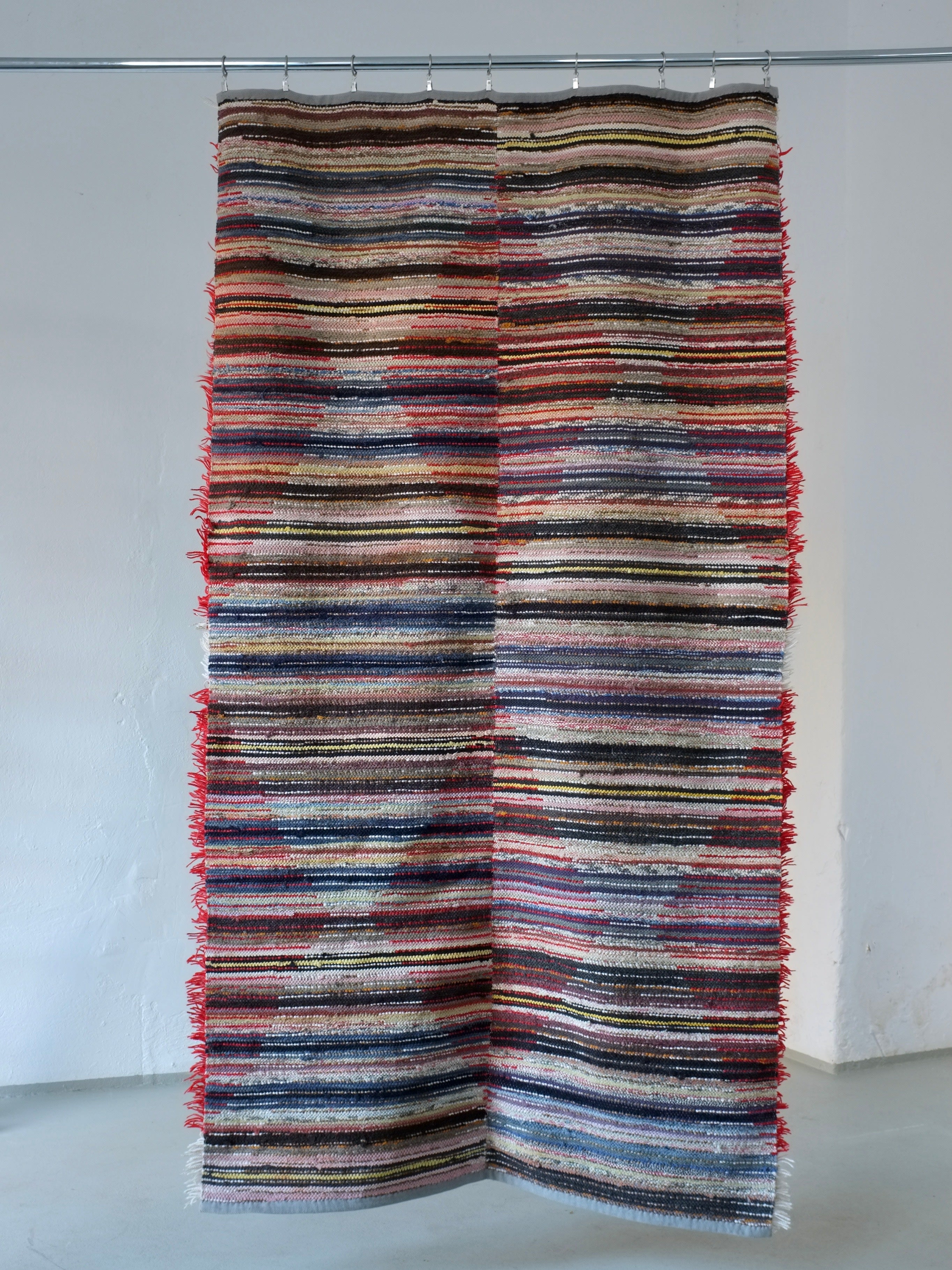 Scandinavian Red Rhombus Wool Rya Rug | Sweden | 1960s — hung on wall in minimalist space