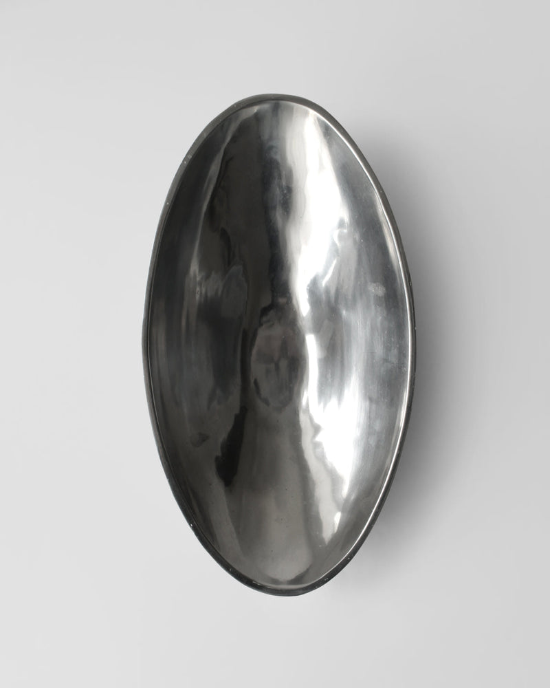 Polished aluminum oval serving bowl with hammered texture finish