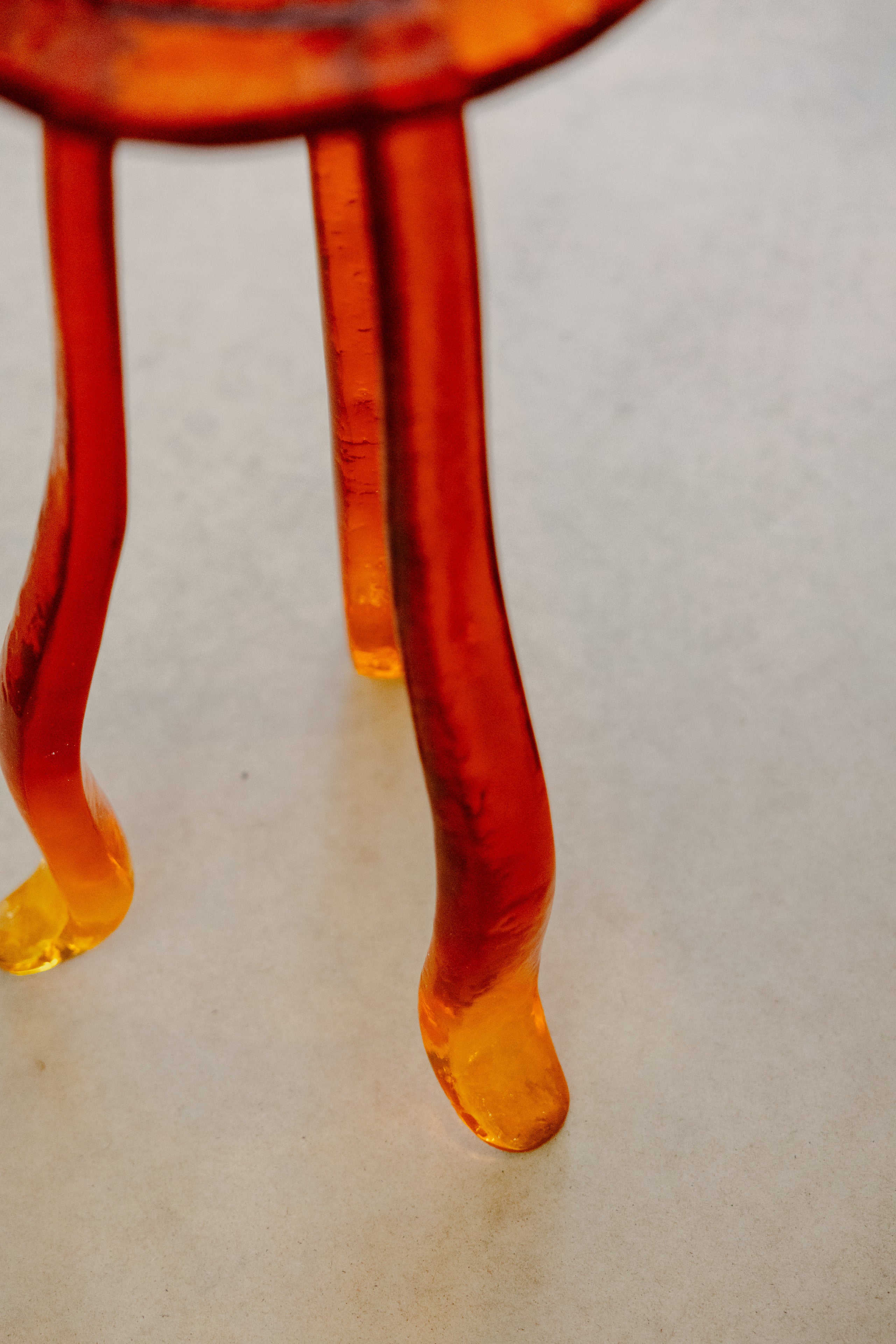Lung 1.0 Ambar Side Table — close-up of amber glass legs