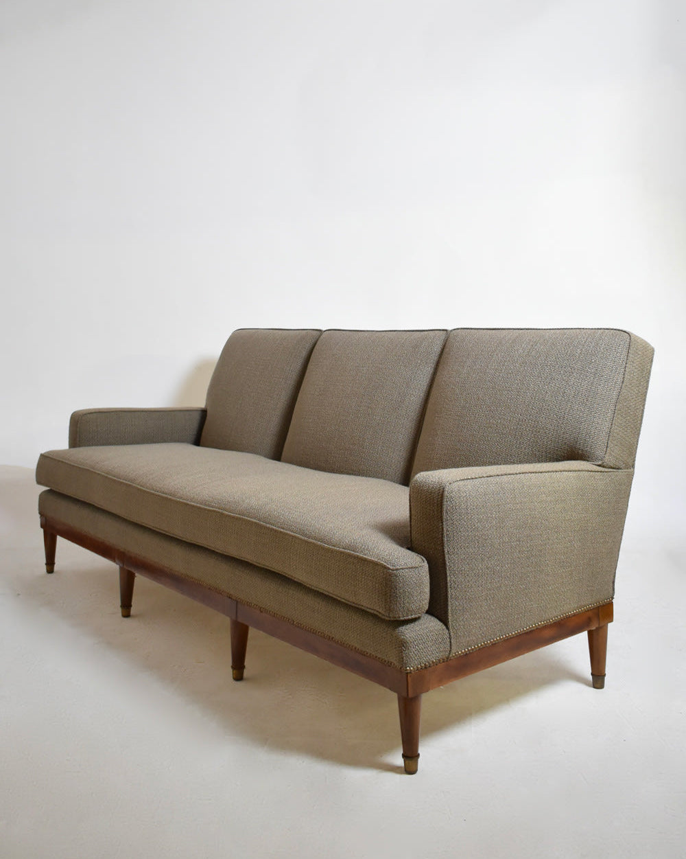 Three Seats Sofa, 1960s — angled view showing gray fabric and wooden legs