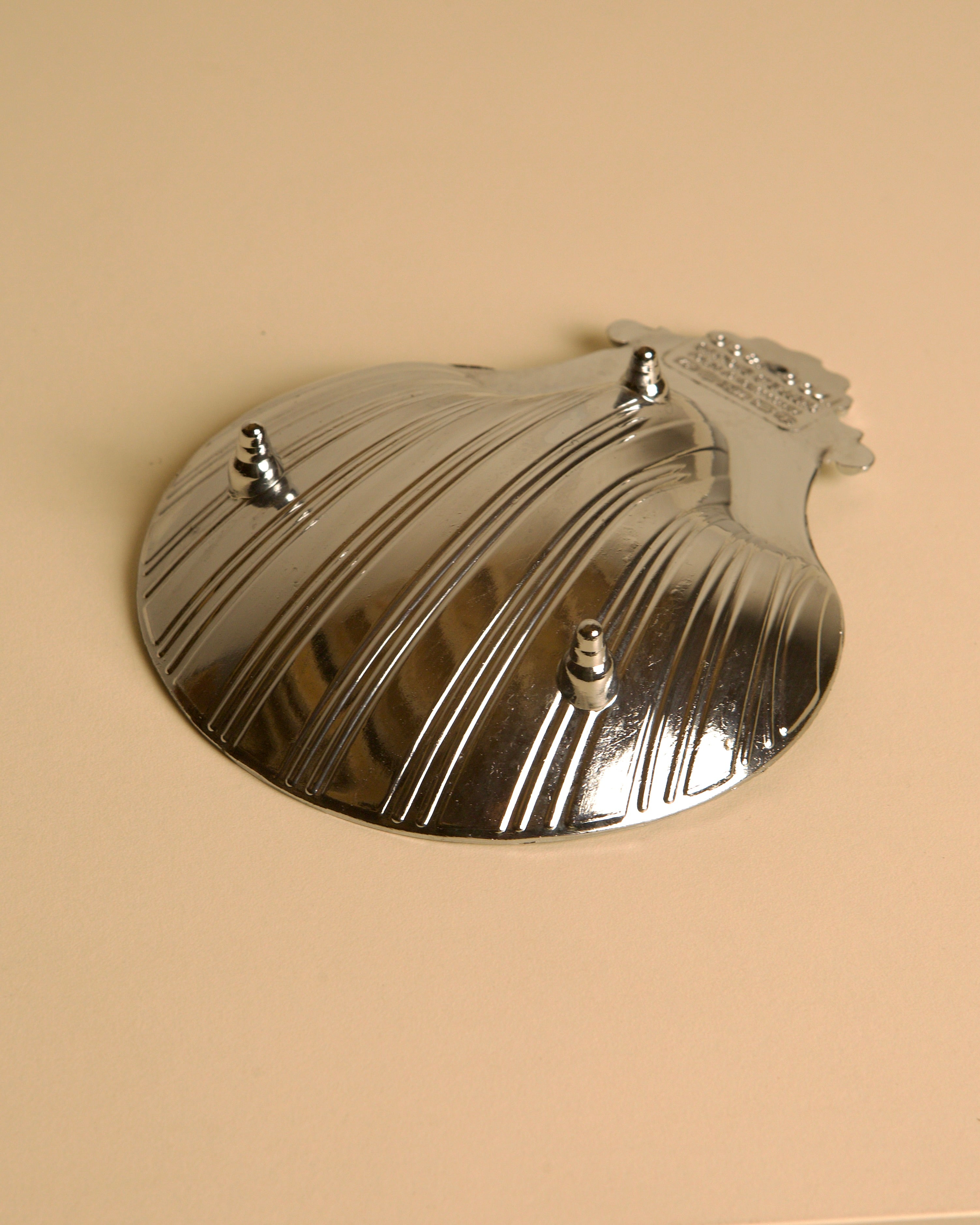 Silver-plated shell dish with ribbed pattern and three decorative studs
