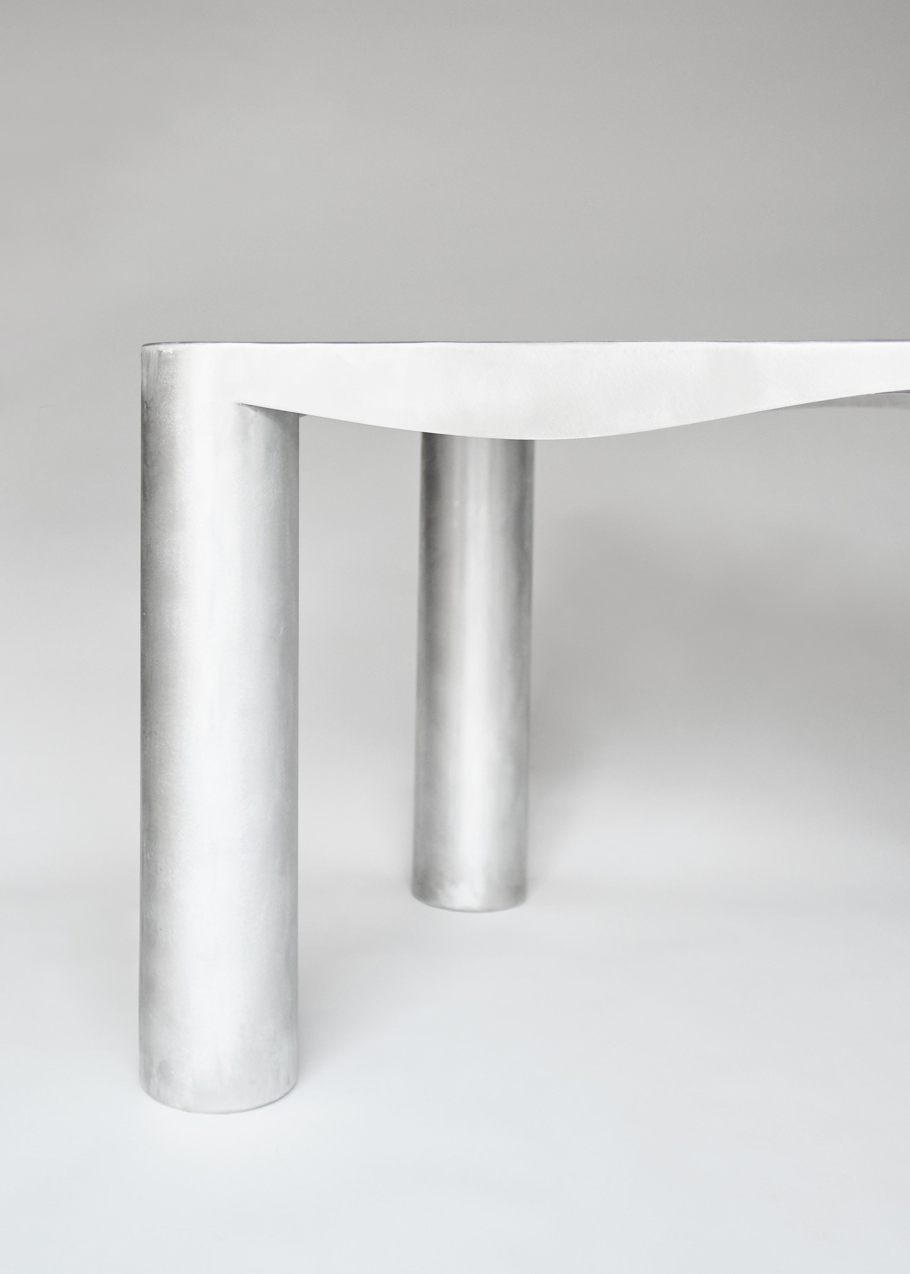 Aluminum Dining Table — side angle highlighting cylindrical legs