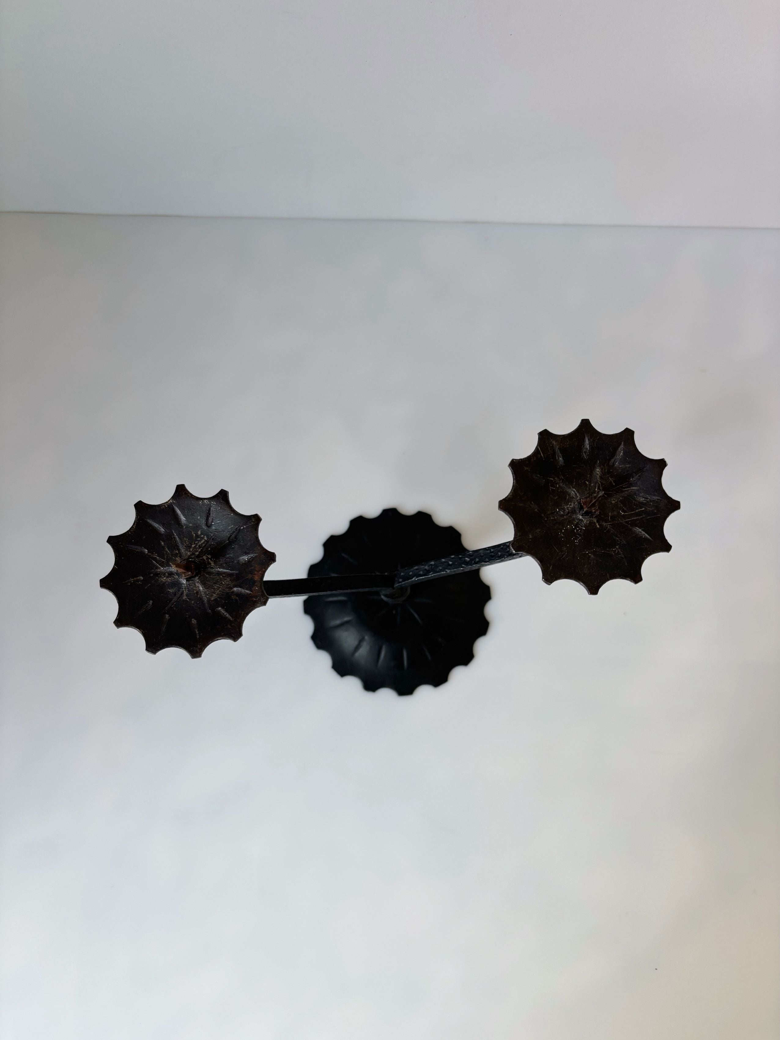 Black metal candleholder with decorative scalloped edges from Poland