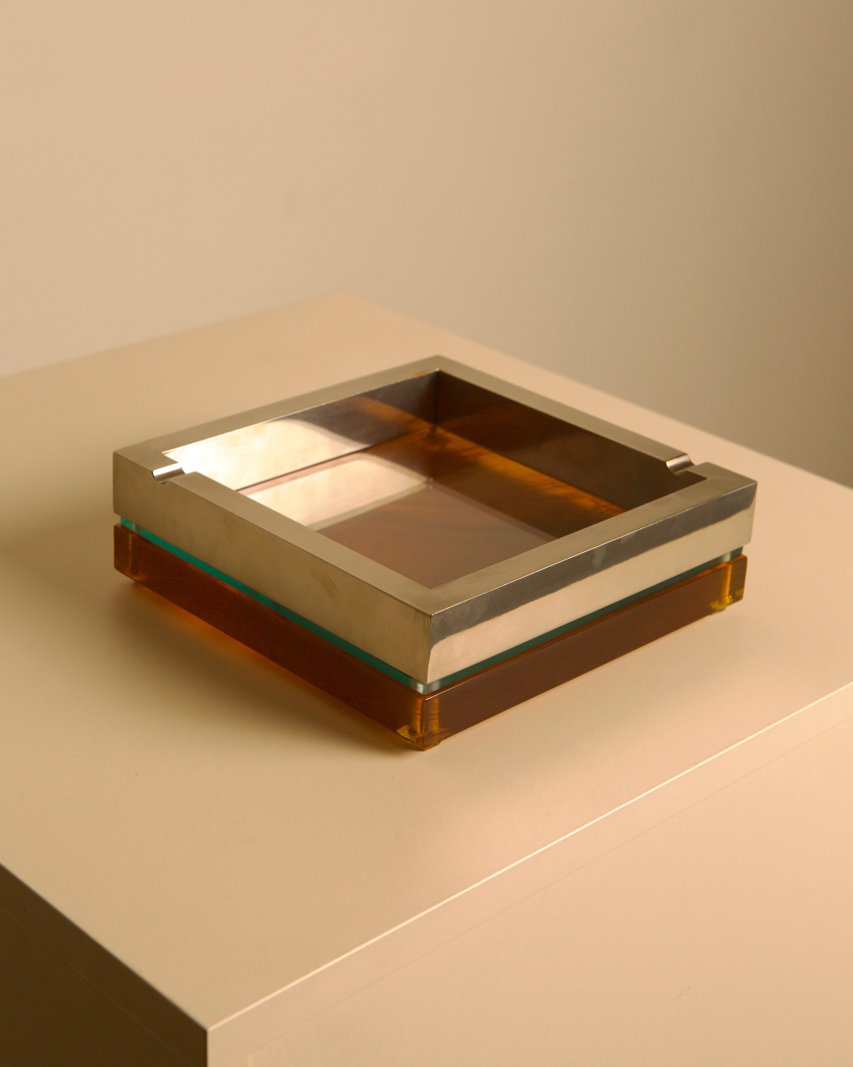 Large 70s Italian square ashtray in metal, glass and light smoked Plexiglas — lifestyle setting